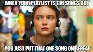 A young white girl wearing headphones, looking off to her right. The text reads: "When your playlist is 136 songs but you just put that one song on repeat."